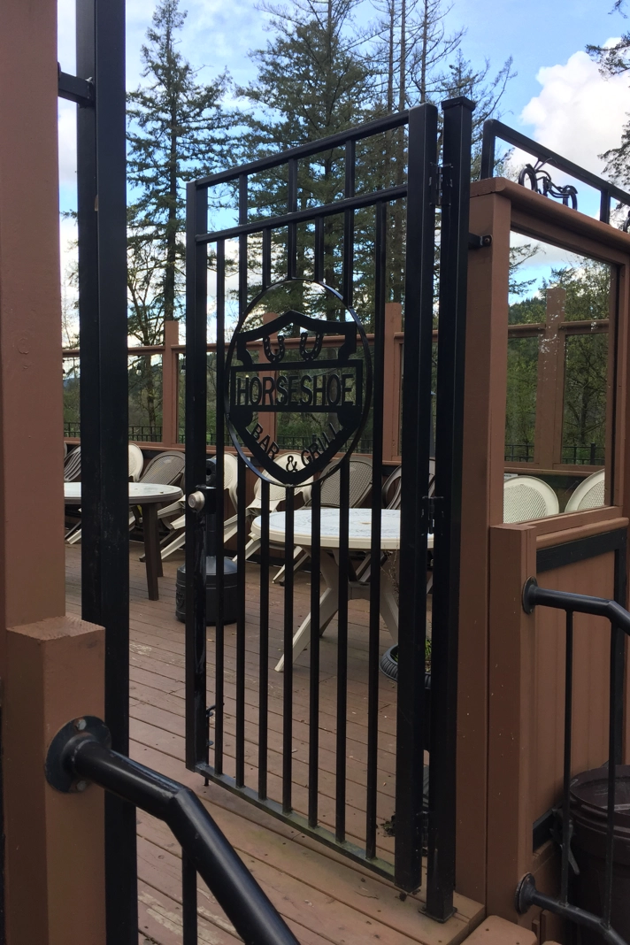 Black metal gate with Horseshoe Bar & Grill logo | Chip and Dale's Iron Works