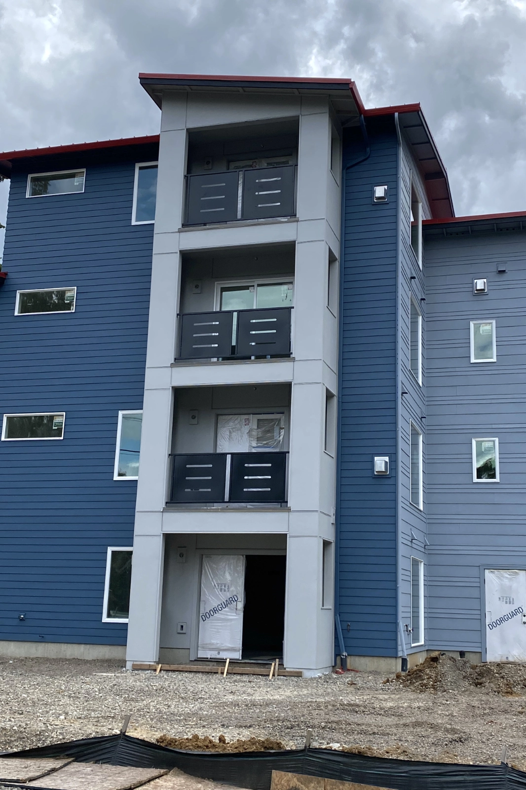 Custom-fabricated black metal balcony railings with modern horizontal slotted privacy panels. | Chip and Dale's Iron Works